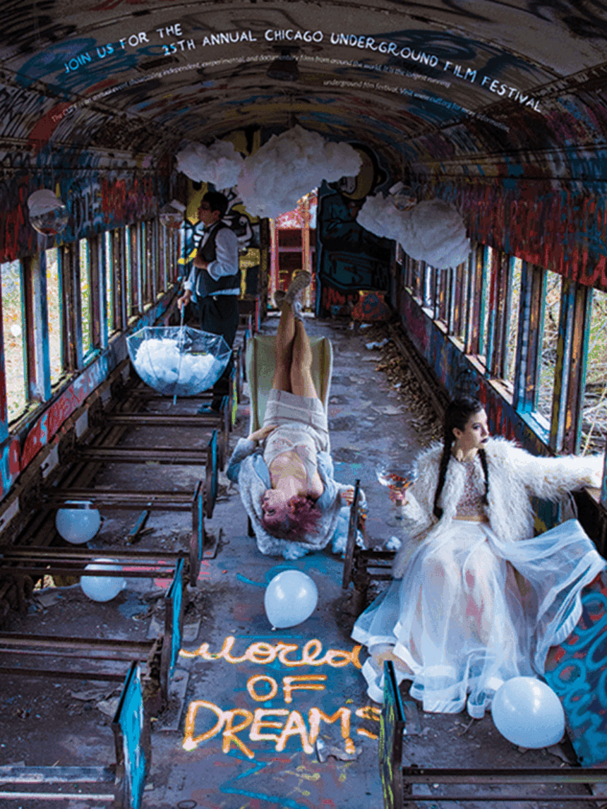 A surreal image of two women inside an old train filled with graffiti and white balloons sparingly placed.