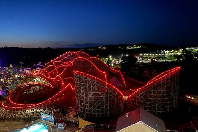 drone photo of a roller coaster with red lights lining the track