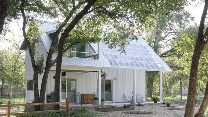 An eco-efficient home with solar panels on the front roof.
