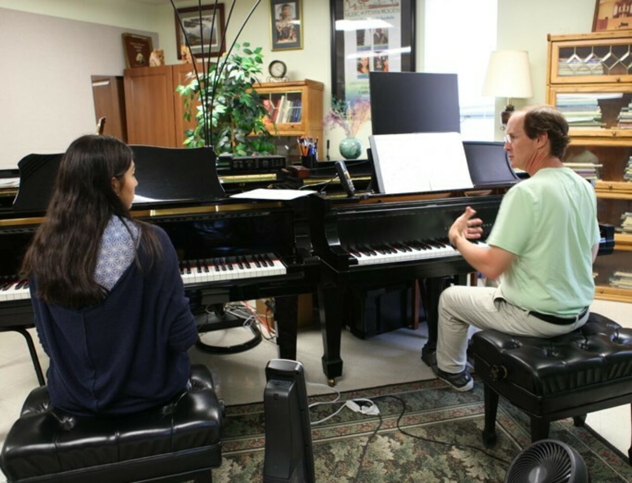 Piano instruction with faculty and student.