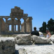 Students sitting at the ruins of Paestum, sketching the architecture.