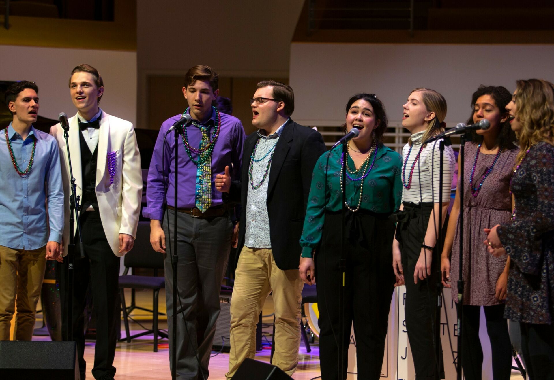 School of Music vocalists performing on stage during the Mardi Gras Jazz Concert at the Recital Hall.