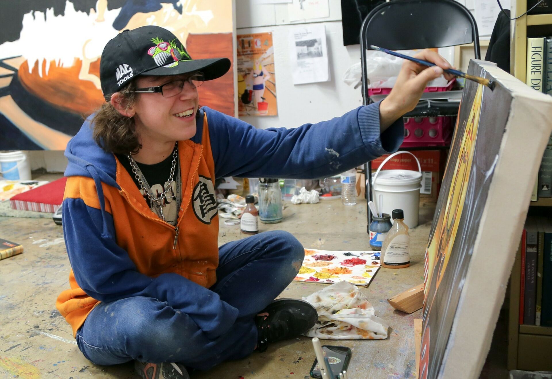 SoVA student painting in studio.