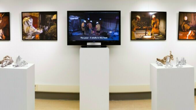 A series of screens on pedestals in the Borland Project Space showcasing videos of art and research projects