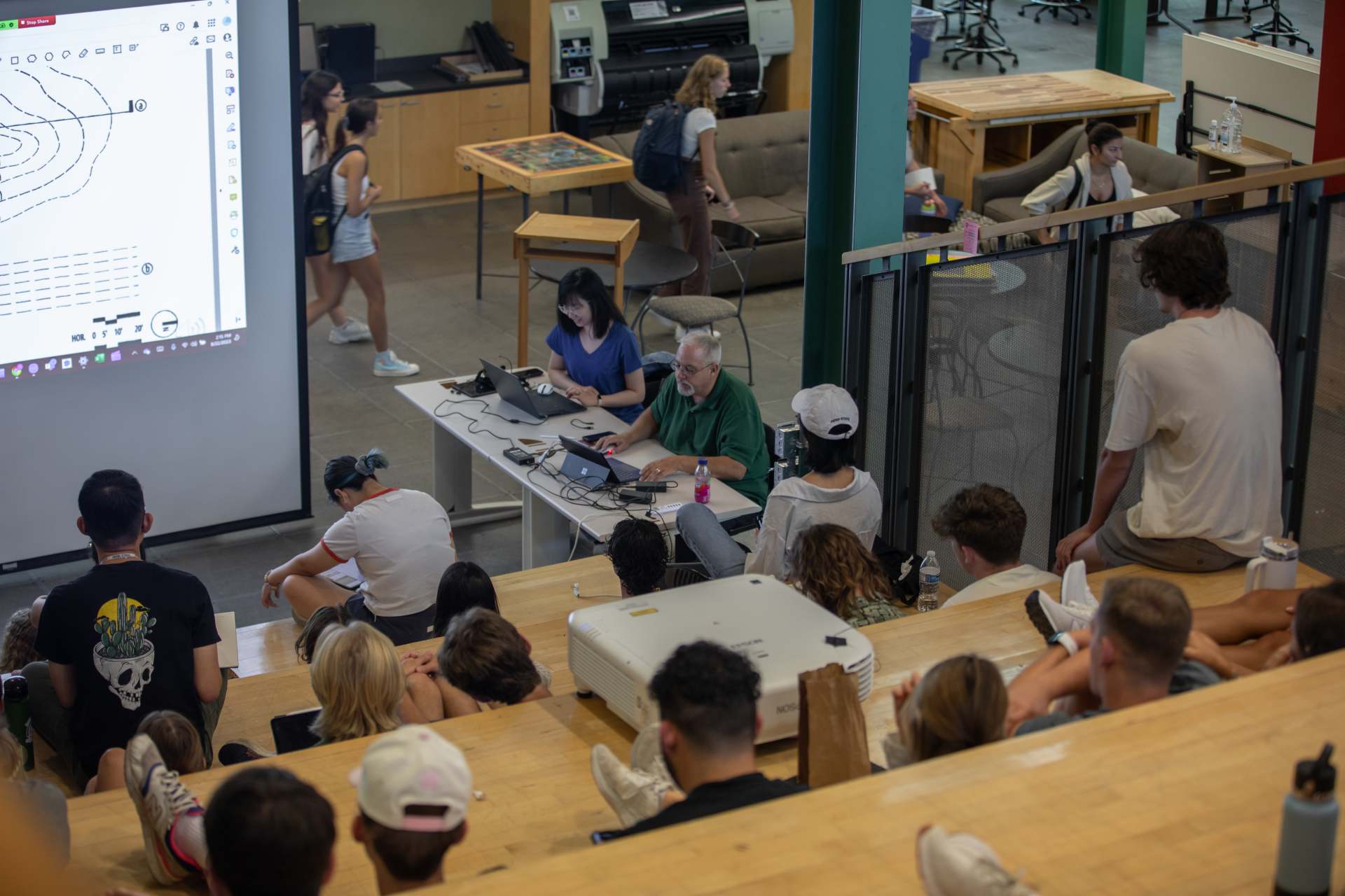 A landscape architecture class sits on the steps of the Stuckeman Family Building  South Forum while the instructor teaches the class.