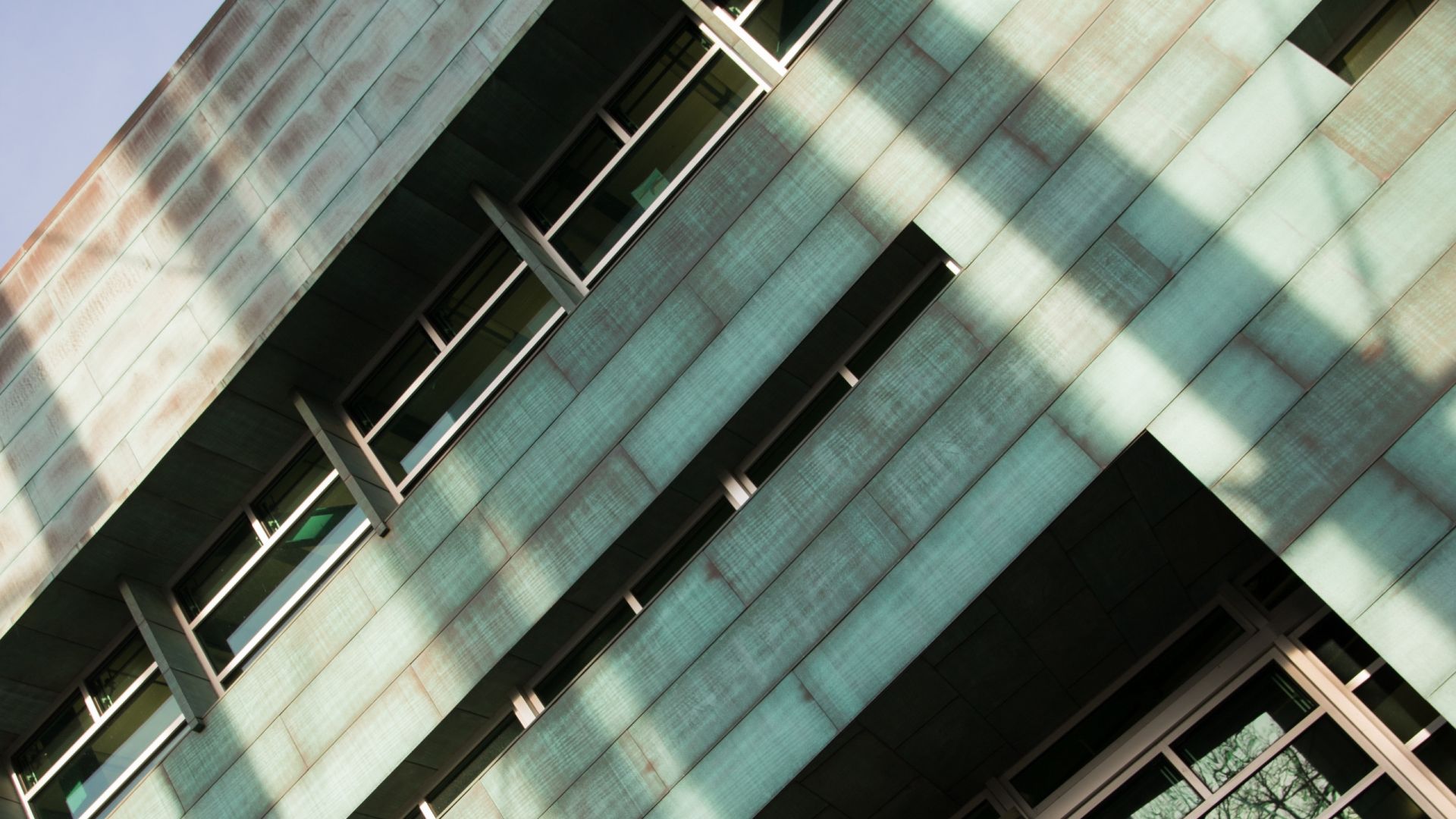Angled close up shot of the greenish-brown patinated copper-clad exterior of the Stuckeman Family Building