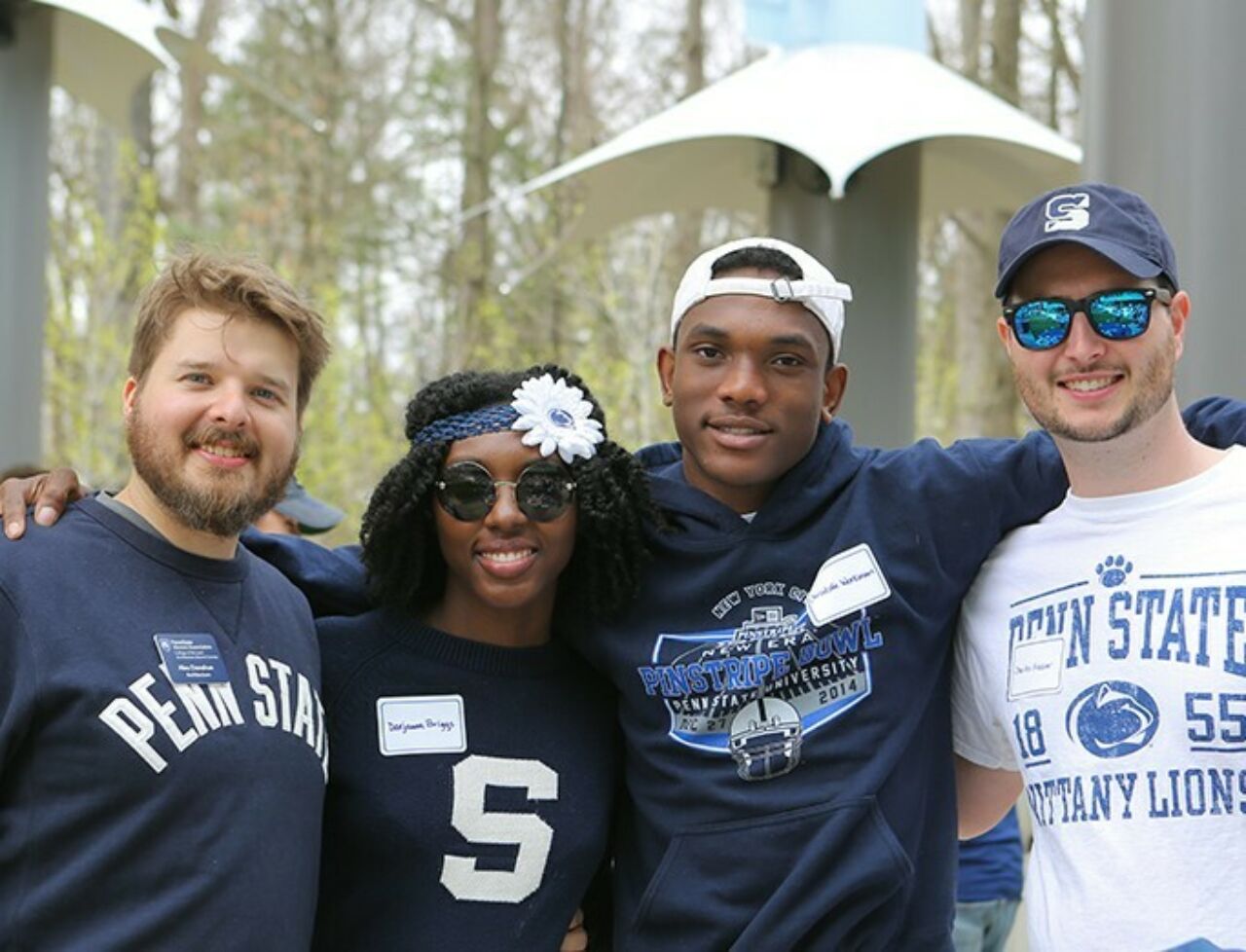 College of Arts and Architecture alumni and friends gather together for a picture during a tailgate party on blue and white weekend.