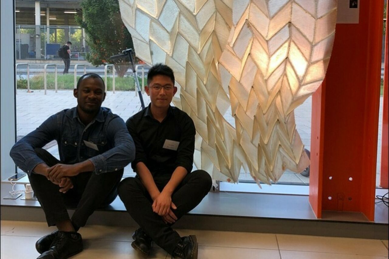 Jimi Demi-Ajayi and Julian Huang in front of their “Phototropic Origami Structure” project in London.