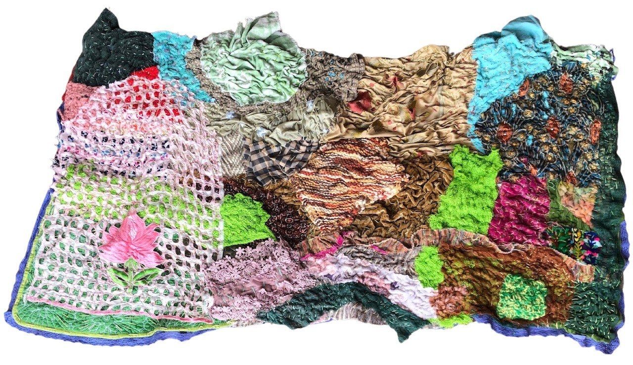 Textile art consisting of many different types of fabric.
