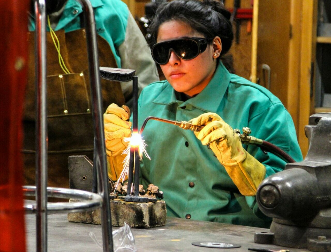 SoVA student using an arc welder fusing metals together.
