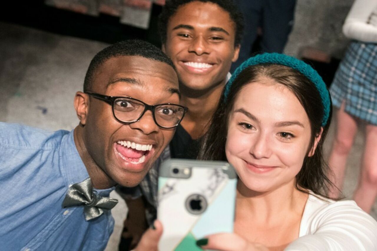 Three student actors taking a selfie during practice for the School of Theatre's production of 'Hooded'