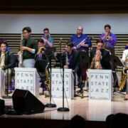 The Penn State Jazz band performs their instruments during the Mardi Gras concert.