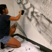 Alec Spangler, assistant professor of landscape design, recruited students, friends and fellow faculty members to help create his massive wall drawing in the Woskob Family Gallery in downtown State College.