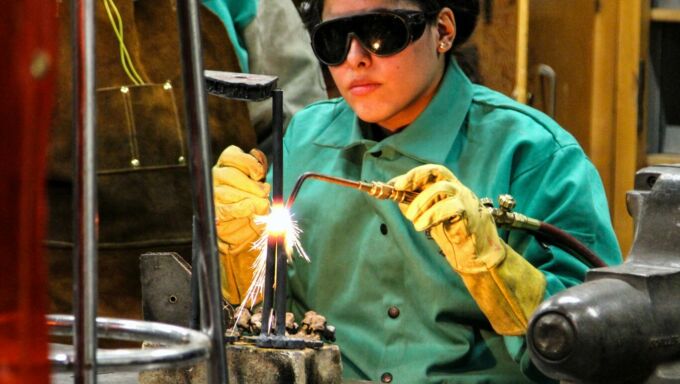 SoVA student using an arc welder fusing metals together.