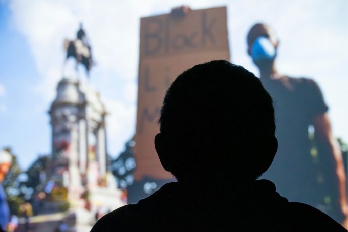 Silhouette of a person watching the Mending Walls Documentary.