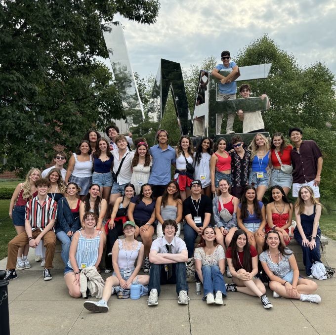 group of summer theatre students posing in front of the WE ARE statue on Penn State University campus.