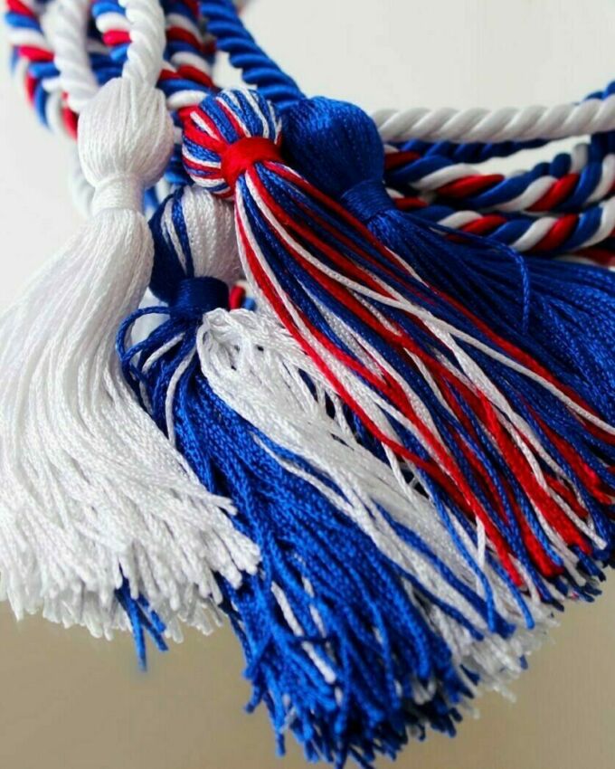close up of a red, white, and blue commencement honor cord