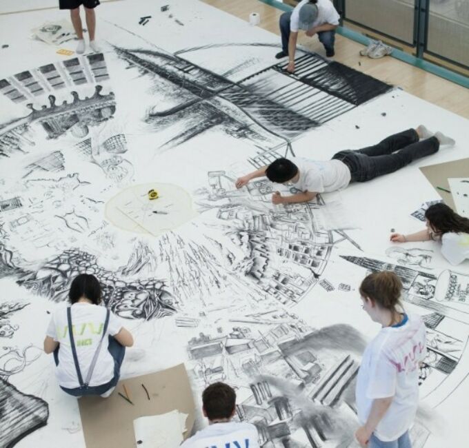 Architecture students working on extremely large format technical charcoal drawing