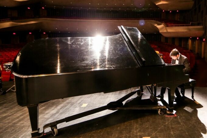 grand piano and pianist on stage at Eisenhower