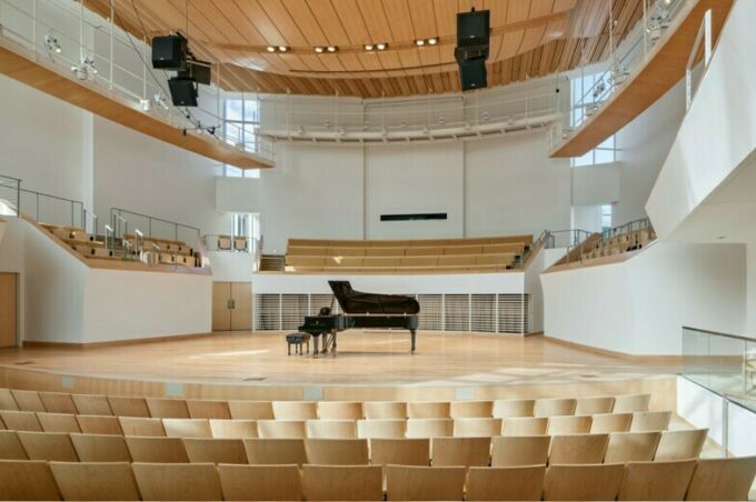 Grand piano on Esber Recital Hall stage, seen from center stage seating.