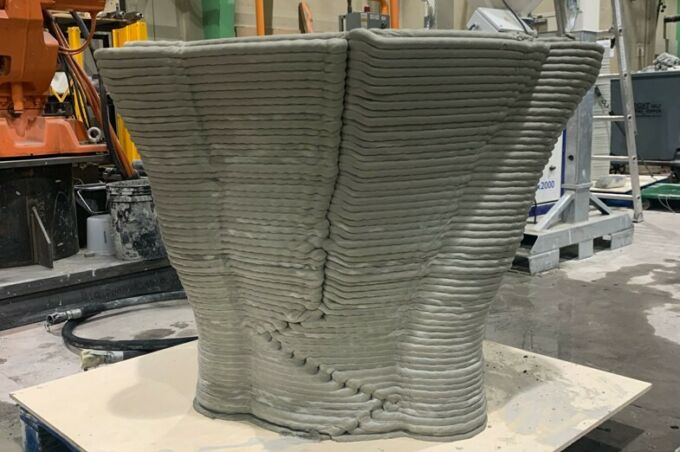 Exterior of 3d-printed hollow concrete form, showing hundreds of stacked layers of printed concrete.
