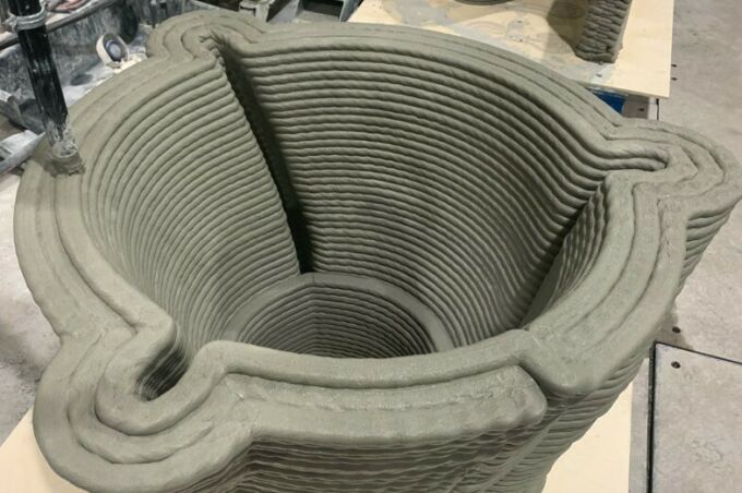 Interior of 3d-printed hollow concrete form, showing stacked, offset layers of printed concrete.