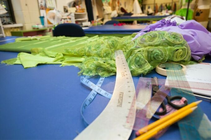 Closeup of fabric and measuring tools used in the costume shop.