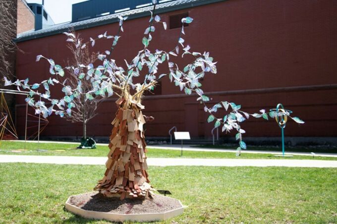 SoVA student artwork of an outdoor sculpture of a tree with vibrant color leaves and a textured tree trunk.