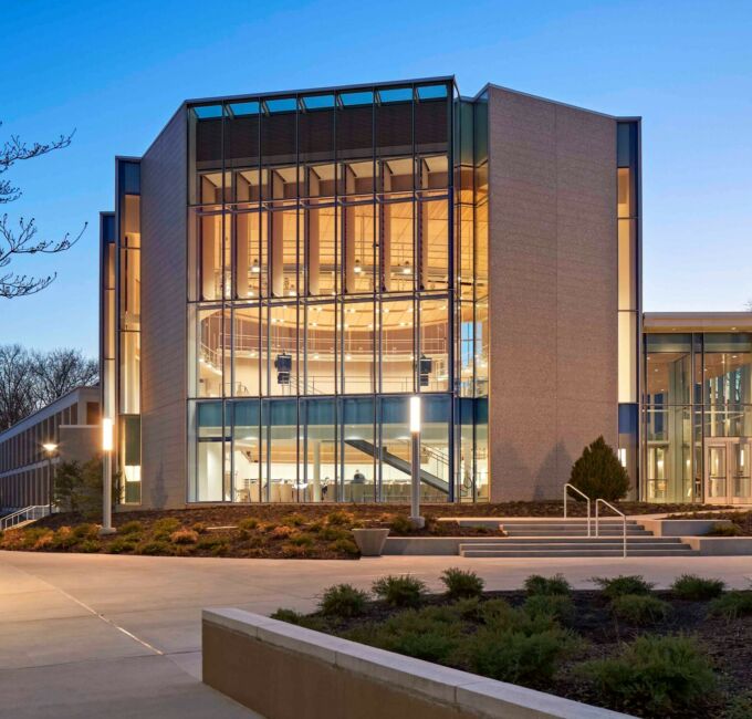 exterior of Recital Hall in evening with glass facade and creamy bricks