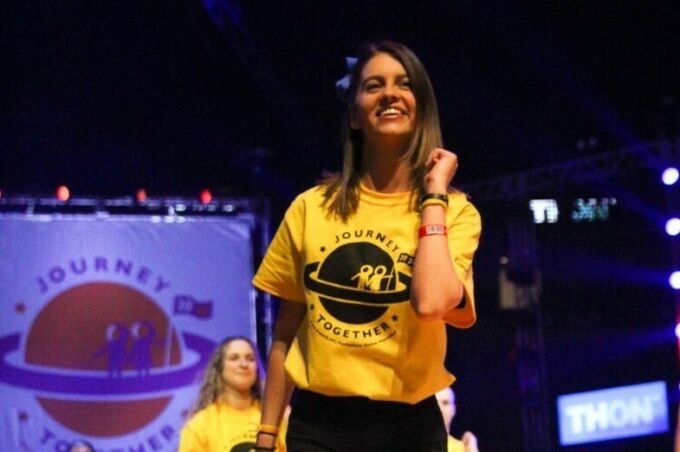 College of Arts and Architecture student performing the Thon line dance on stage in the Bryce Jordan Center.