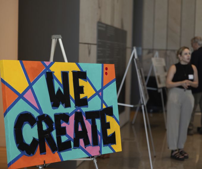 "We Create" canvas on display in the new Palmer Museum of Art's lobby.