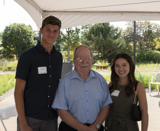 Group photo of two A&A students with a donor.