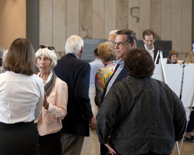 A group of attendees in conversation with each other.