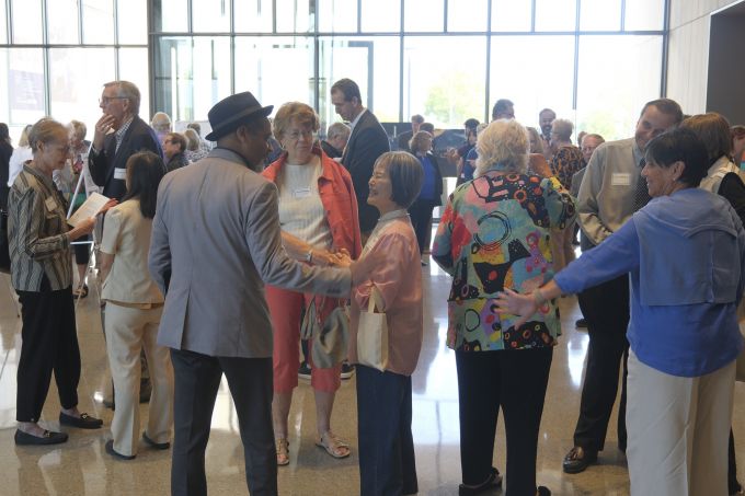 Dean Carpenter speaks with the attendees in the new Palmer Museum of Art's lobby.