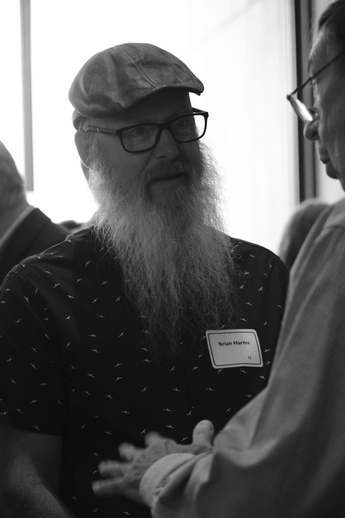 Brian Harms in conversation with another attendee.