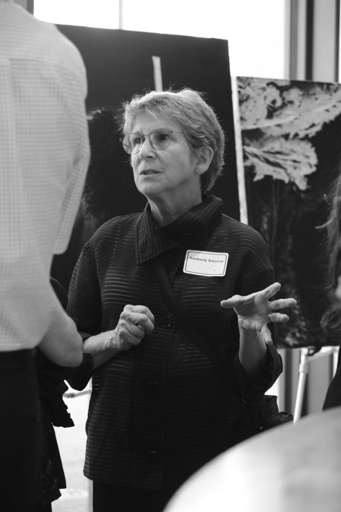 Kimberly Schenck speaking to other event attendees.