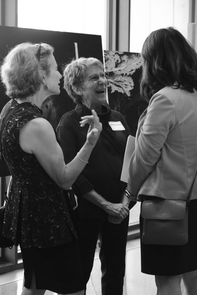 Kimberly Schenck (center) laughing with two other women.