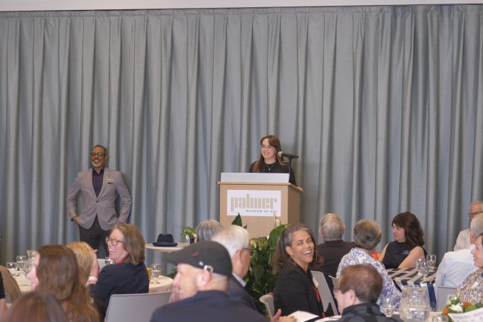 Donor Appreciation attendees sitting at tables, listening to the speaker at the podium.