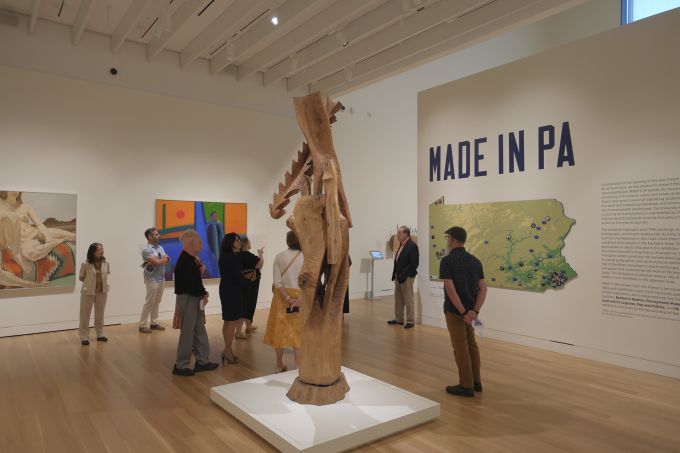 A group of people touring the "Made in PA" exhibit of the new Palmer Museum of Art.