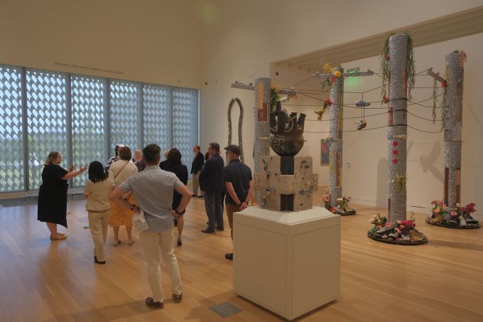 A group of people touring the new Palmer Museum of Art.