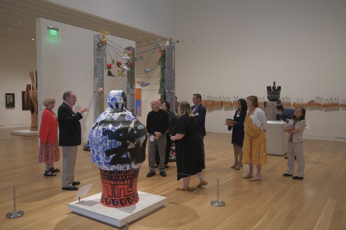 A group of people touring the new Palmer Museum of Art.