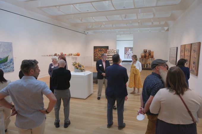 A group of people touring the new Palmer Museum of Art.