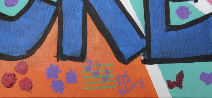 Close-up of handpainted "We Create" canvas.