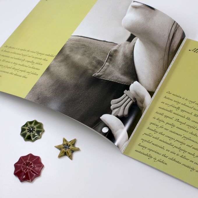Tokmeh Couture brand book and pins.