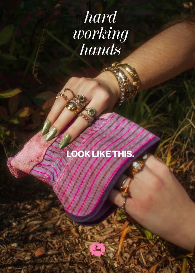 A magazine add for John Deere featuring manicured women's hands holding a colorful gardening glove.