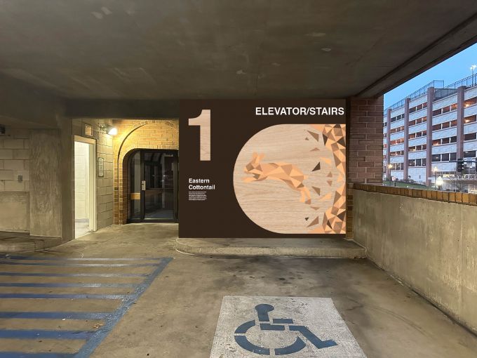 A mural that uses neutral colors that indicates the elevators and stairs on the first floor of a parking garage.