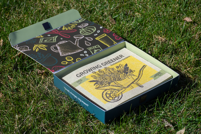 An opened designed package and book for the Growing Greener publication.