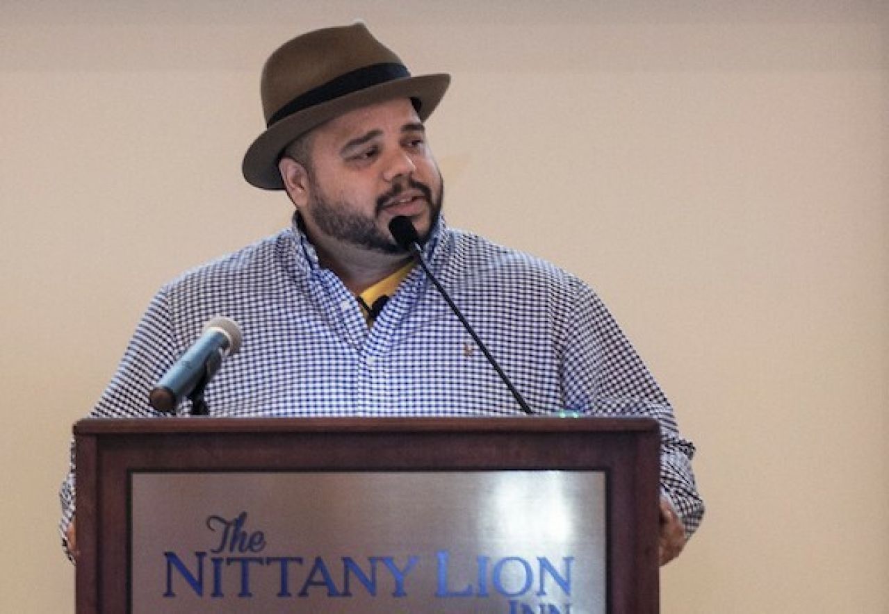 Roberto Lugo speaking at a podium