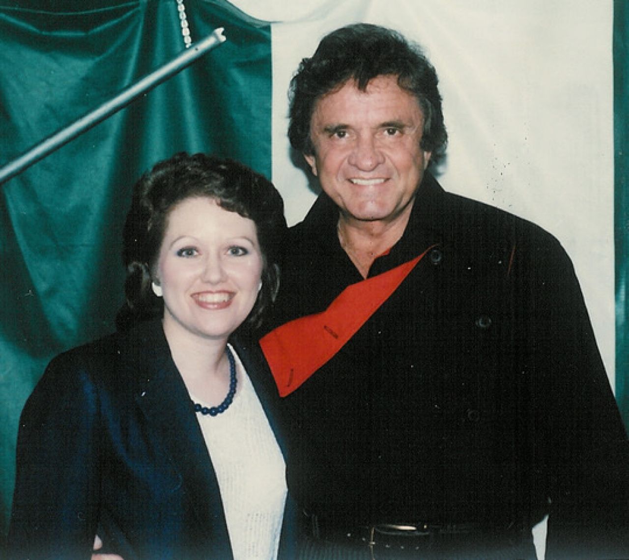 A man and woman stand side by side and smile.