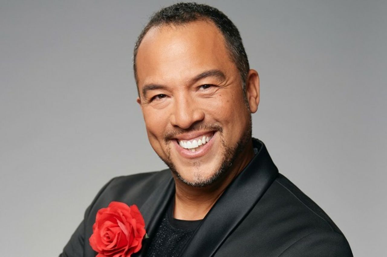 A man smiles broadly.